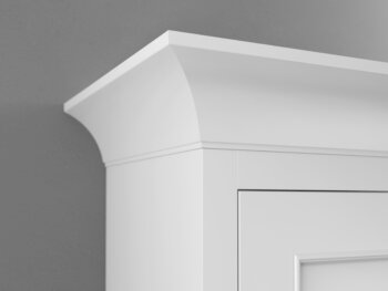 A close up corner of Cove Molding at the top of a kitchen cabinet from Dura Supreme Cabinetry.